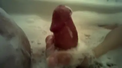 Big tittied hottie gives a handjob in a bubble bath pov