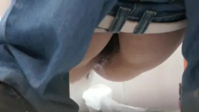 Dark haired asian chick pissing on