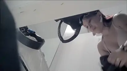 Asian chick showing her melons in the dressing room